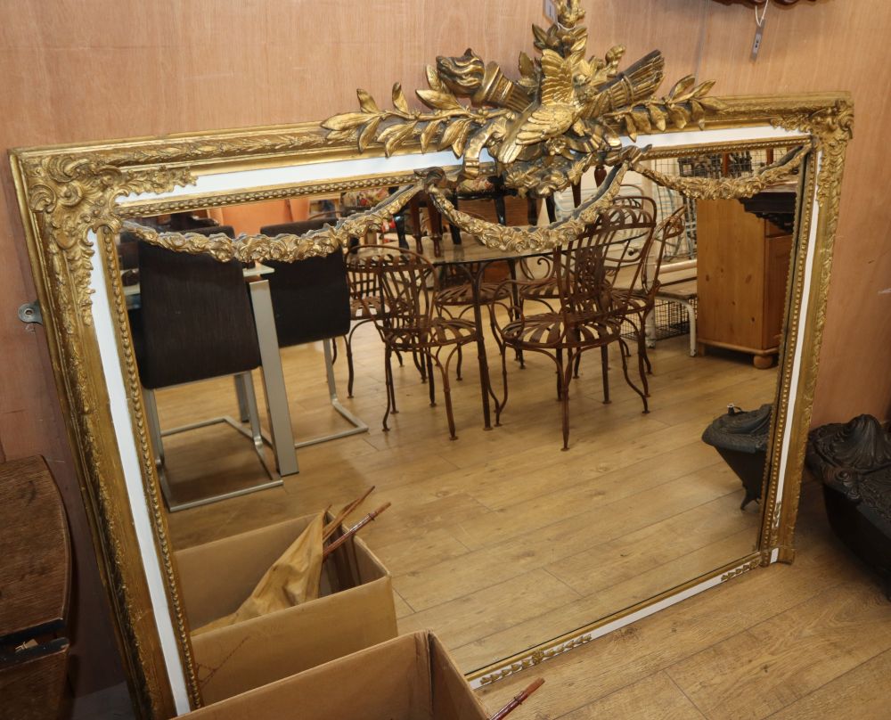 A gilt-framed rectangular overmantel mirror with bird and flambeau surmount and swag decoration, W.155cm, H.134cm